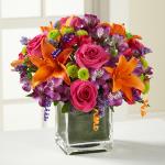 Reference # D2-5189
Starting at  $   49.99                        Hot pink roses and orange Asiatic Lilies  vibrant by purple Peruvian Lilies, hot pink mini carnations, green button poms, purple statice & an assortment of lush greens. Accented with assorted curling ribbons .