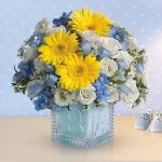 Reference #  T34-2B
Starting at $44.95
The glass block will make an adorable display piece for years!<br/><br/>Dazzling white spray roses, light blue delphinium, white waxflower and light blue organza ribbon are delivered in a clear baby block with a light blue liner.