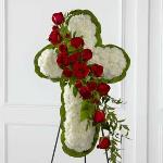 Reference # S12-4464
Standing Cross
White carnations are arranged to form a cross in which an accent of red roses, spray roses, and lush greens are draped across the center, 