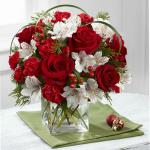 Reference # B14-4965
Starting at $54.99
ich red roses and mini carnations are beautifully accented with white Peruvian lilies, red hypericum berries, lily grass blades, and an assortment of lush holiday greens to create an exceptional fresh flower arrangement. Presented in a clear glass cube, this h