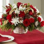 Reference # B17-5134
Starting at $49.99
 Rich red roses, red mini carnations, white chrysanthemums, red hypericum berries, and fresh Christmas greens are accented with natural pine cones and a stylish red, green, and white striped grosgrain ribbon while situated in a round white wash woven handled b
