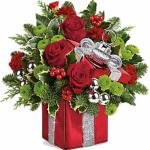 Reference # T16
Starting at $54.99
his will surely be a holiday décor favorite for years to come! This festive mix features red roses, red miniature carnations, green button spray chrysanthemums, flat cedar, variegated holly and noble fir. Delivered in Teleflora's Gift Wrapped ornament keepsake box.