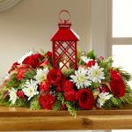 Reference #16-C3 
Starting at $ 69.99
Red roses, carnations, and mini carnations are beautifully arranged amongst white chrysanthemums, and an assortment of holiday greens all surrounding an attractive red lantern with a lattice pattern housing a single white votive candle. A great gift for friends 