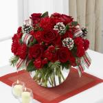 Reference #  B10-4962
Starting at $ 49.99
Rich red roses are a standout arranged amongst red carnations and mini carnations, red hypericum berries and an assortment of lush holiday greens. 
