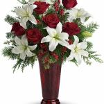 Reference # T117-1A 
Starting at $ 72.95
An elegant Christmas arrangement of white asiatic lilies, red roses and Douglas fir, this fabulously fragrant gift lends seasonal sparkle to any room.\nWhite asiatic lilies, red roses, Douglas fir, seeded eucalyptus and small red berries .