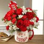 Reference #16-C7
Starting at $49.99
 We bring together red roses, carnations, and mini carnations mingling with snowy white Peruvian lilies and an assortment of Christmas greens, arranged to perfection in a keepsake ceramic Santa mug with the word, "Believe," at the bottom in a lively font. P