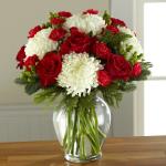 Reference #16-C7
Starting at  $59.99
Gorgeous and full white snowball chrysanthemums are not to be upstaged when arranged amongst rich red roses, red carnations, and red mini carnations, accented with red hypericum berries and assorted Christmas greens to create a standout yuletide display