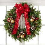 Reference # B9-5140
Starting at $85.99
With a base consisting of fresh and fragrant Christmas greens, this wreath is bedecked with white tipped pine cones, shining red and gold glass holiday balls, and clusters of berries, culminating in a standout red bow at the top.