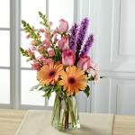 Reference # B21-5145
Starting at $ 52.95
 Peach gerbera daisies are soft and sophisticated surrounded by pink roses, pink snapdragons, pink mini carnations, purple liatris, and lush greens arranged with an artist's eye in a  clear glass vase.
