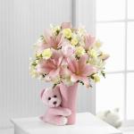 Reference # 
Starting at $45.99
Pastel pink roses combine with pale yellow mini carnations, white Peruvian lilies, pink Asiatic lilies and a variety of lush greens, all perfectly presented in a blushing pink ceramic vase hugged by a darling matching pink plush bear.