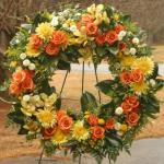 Reference # JBS 203
Orange roses with yellow cymbidium orchids. 
assorted mums and greenery. 

as shown $ 225.00
